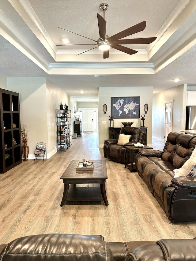 2405 Dakota Way, Crestview, FL 32536 - living area featuring a raised ceiling, crown molding, a ceiling fan, and wood finished floors