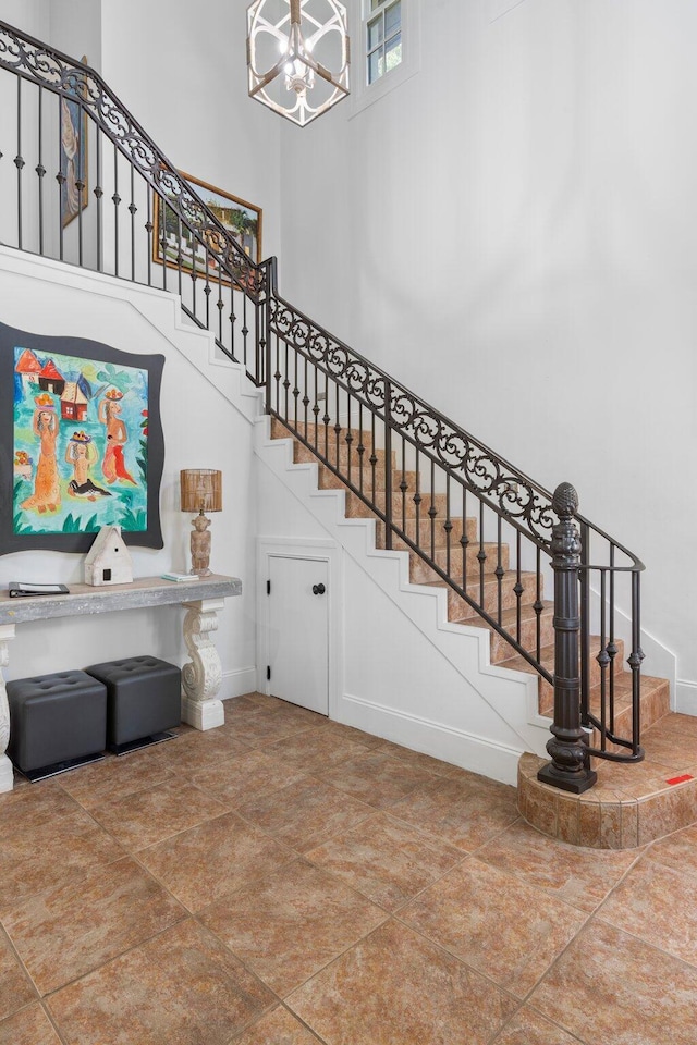 176 Rue Martine, Miramar Beach, FL 32550 - staircase featuring a chandelier and a high ceiling