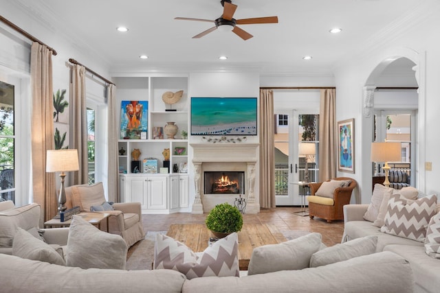 176 Rue Martine, Miramar Beach, FL 32550 - living room featuring ceiling fan, arched walkways, recessed lighting, a lit fireplace, and ornamental molding