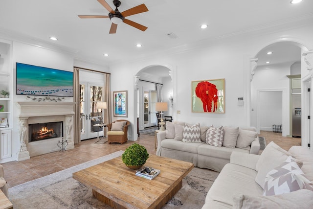 176 Rue Martine, Miramar Beach, FL 32550 - living area featuring arched walkways, a ceiling fan, recessed lighting, a premium fireplace, and crown molding