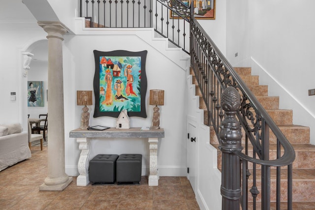 176 Rue Martine, Miramar Beach, FL 32550 - staircase featuring decorative columns and a high ceiling