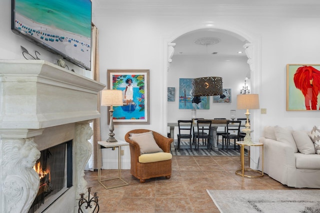 176 Rue Martine, Miramar Beach, FL 32550 - living room featuring crown molding, arched walkways, a premium fireplace, and tile patterned floors