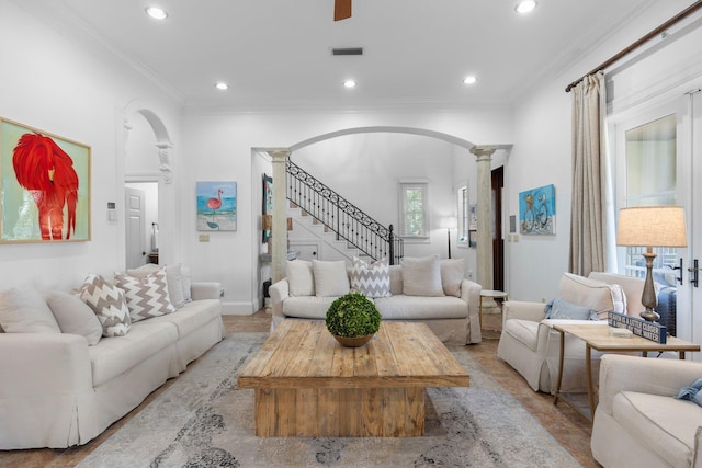 176 Rue Martine, Miramar Beach, FL 32550 - living area featuring arched walkways, decorative columns, ornamental molding, recessed lighting, and stairs