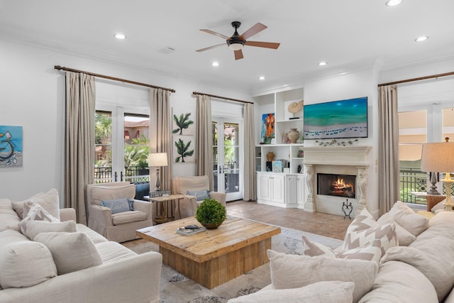 176 Rue Martine, Miramar Beach, FL 32550 - living area with crown molding, a warm lit fireplace, a ceiling fan, healthy amount of natural light, and recessed lighting