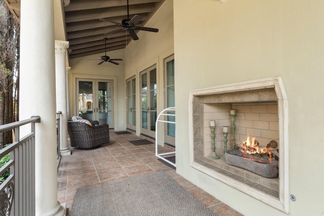 176 Rue Martine, Miramar Beach, FL 32550 - view of patio / terrace featuring a lit fireplace, french doors, and ceiling fan