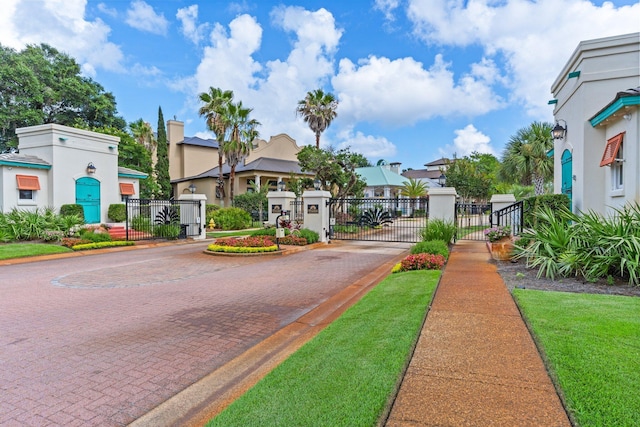 176 Rue Martine, Miramar Beach, FL 32550 - view of decorative road with a gate, a gated entry, curbs, and a residential view