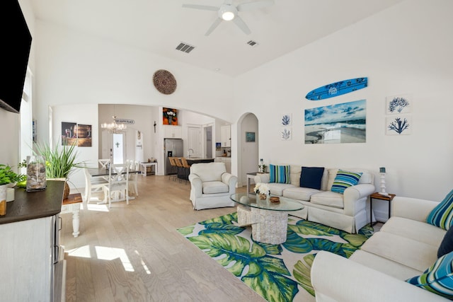 234 Grande Pointe Cir, Inlet Beach, FL 32461 - living room featuring arched walkways, a ceiling fan, light wood-style flooring, and a chandelier