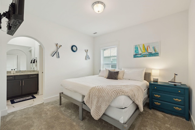 234 Grande Pointe Cir, Inlet Beach, FL 32461 - bedroom featuring carpet floors, arched walkways, and ensuite bath