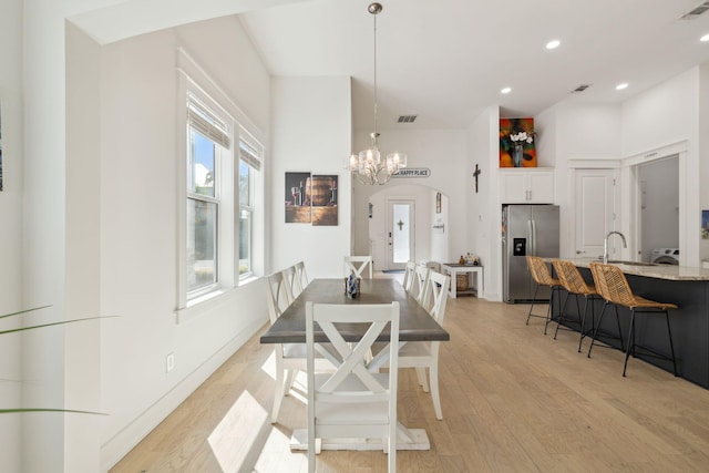 234 Grande Pointe Cir, Inlet Beach, FL 32461 - dining room featuring a chandelier, light wood-style floors, arched walkways, and recessed lighting