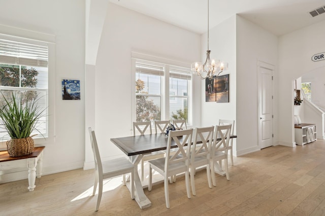 234 Grande Pointe Cir, Inlet Beach, FL 32461 - dining room featuring light wood finished floors, plenty of natural light, a chandelier, and arched walkways