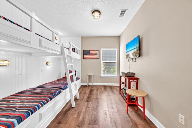 211 Tahitian Way, Destin, FL 32541 - bedroom featuring wood finished floors and a textured ceiling