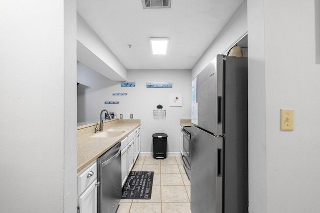 200 Sandestin Ln Apt 1209, Miramar Beach, FL 32550 - kitchen with stainless steel appliances, light tile patterned floors, and white cabinetry