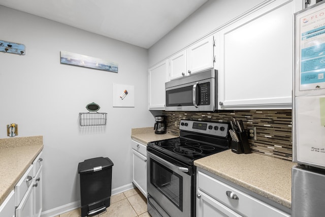 200 Sandestin Ln Apt 1209, Miramar Beach, FL 32550 - kitchen featuring appliances with stainless steel finishes, backsplash, white cabinets, light tile patterned floors, and light countertops