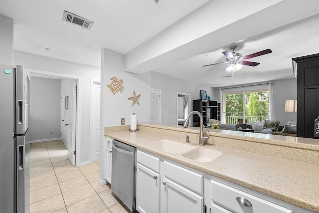 200 Sandestin Ln Apt 1209, Miramar Beach, FL 32550 - kitchen featuring stainless steel appliances, light tile patterned floors, ceiling fan, white cabinets, and light stone countertops