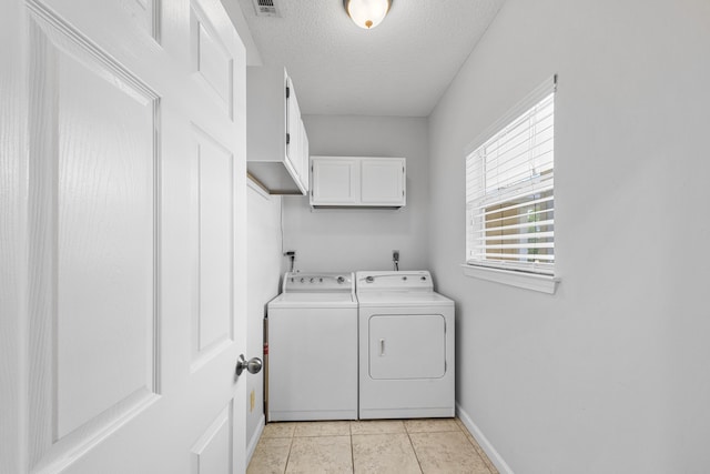 200 Sandestin Ln Apt 1209, Miramar Beach, FL 32550 - laundry area with cabinet space, washing machine and clothes dryer, a textured ceiling, and light tile patterned floors