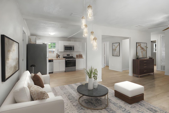 1023 W Webster Dr, Pensacola, FL 32505 - living room featuring light wood-style flooring and a ceiling fan