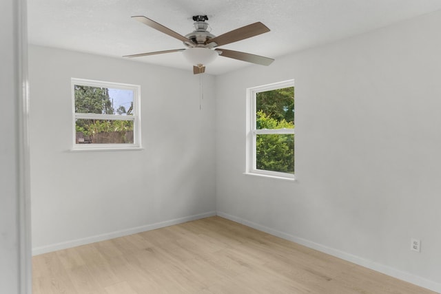 1023 W Webster Dr, Pensacola, FL 32505 - spare room featuring light wood-type flooring, plenty of natural light, and ceiling fan