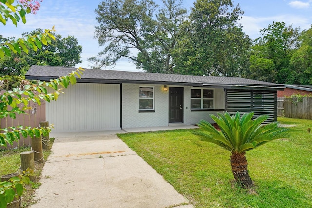 1023 W Webster Dr, Pensacola, FL 32505 - view of front of house with concrete driveway, brick siding, and a shingled roof
