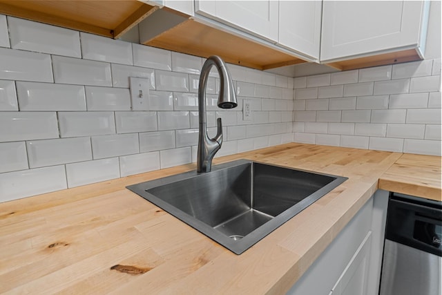 1023 W Webster Dr, Pensacola, FL 32505 - kitchen with wooden counters, dishwasher, tasteful backsplash, and white cabinetry