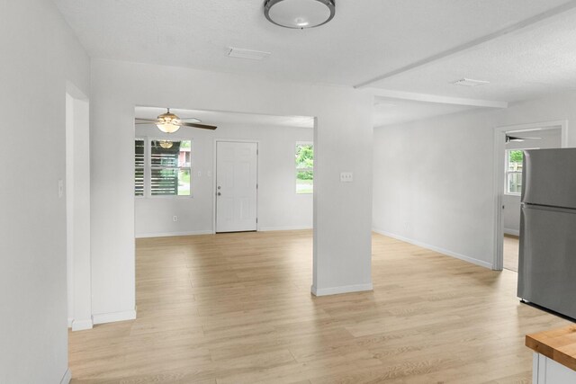 1023 W Webster Dr, Pensacola, FL 32505 - unfurnished living room with a ceiling fan, plenty of natural light, and light wood-style flooring