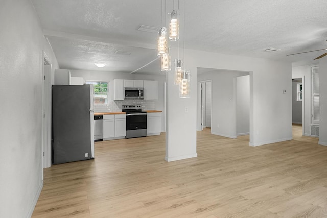 1023 W Webster Dr, Pensacola, FL 32505 - kitchen with stainless steel appliances, a textured ceiling, wooden counters, open floor plan, and tasteful backsplash