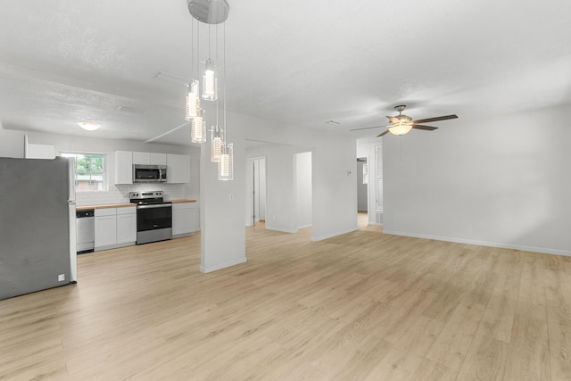 1023 W Webster Dr, Pensacola, FL 32505 - unfurnished living room featuring light wood finished floors and a ceiling fan
