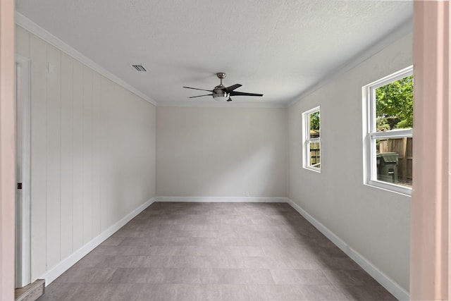 1023 W Webster Dr, Pensacola, FL 32505 - unfurnished room featuring ceiling fan, ornamental molding, a textured ceiling, and tile patterned floors