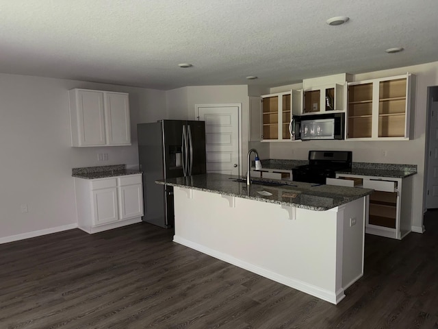 2825 Patriot Ridge Dr, Crestview, FL 32539 - kitchen with black stove, stainless steel microwave, open shelves, fridge with ice dispenser, and dark wood-style floors