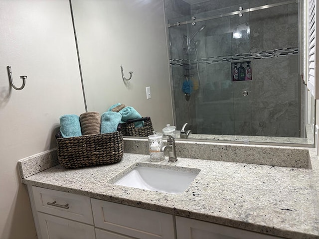 3861 Indian Trl Unit 104, Destin, FL 32541 - bathroom with vanity and a shower stall