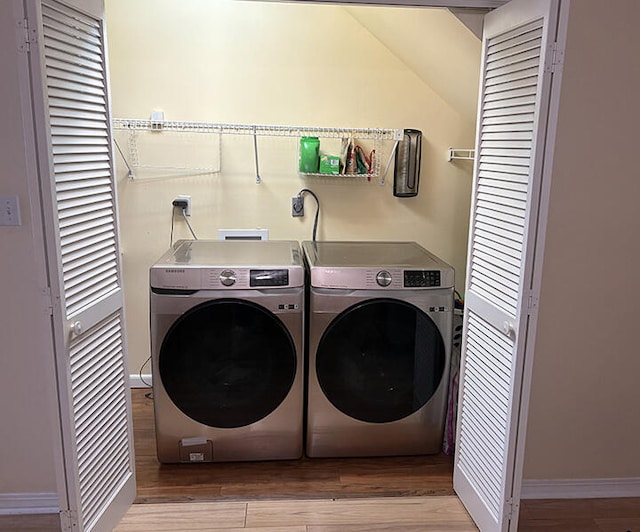 3861 Indian Trl Unit 104, Destin, FL 32541 - washroom featuring washer and dryer and wood finished floors