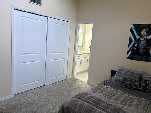 3861 Indian Trl Unit 104, Destin, FL 32541 - bedroom featuring light colored carpet, a closet, and ensuite bathroom