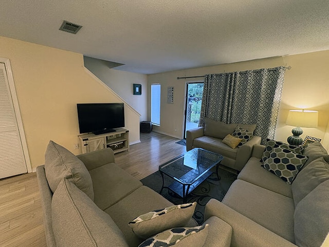 3861 Indian Trl Unit 104, Destin, FL 32541 - living room featuring wood finished floors and a textured ceiling