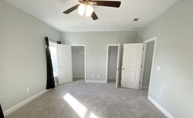 196 Johnson Ct, Crestview, FL 32536 - unfurnished bedroom with two closets, light carpet, and ceiling fan