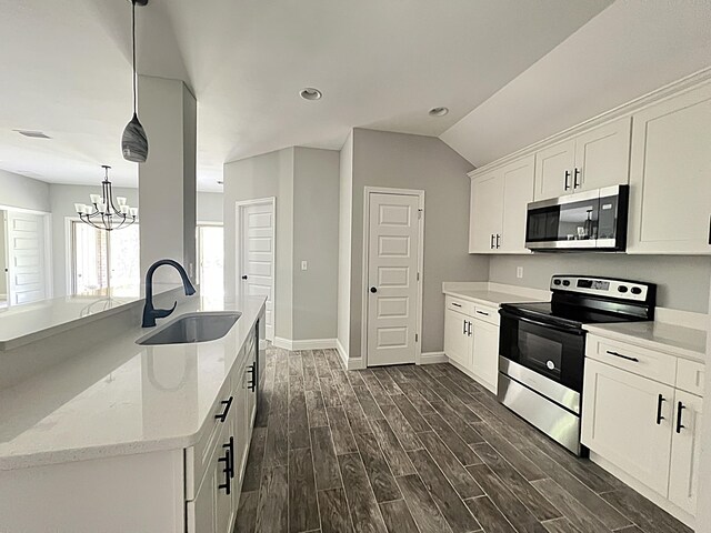245 Cassady Ln, Crestview, FL 32539 - kitchen featuring appliances with stainless steel finishes, dark wood finished floors, white cabinets, a chandelier, and light stone counters