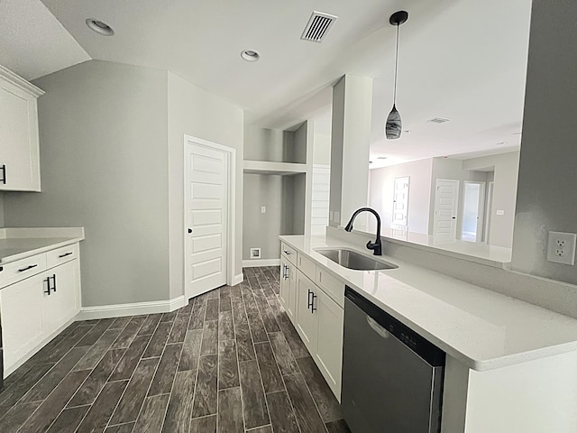 245 Cassady Ln, Crestview, FL 32539 - kitchen featuring stainless steel dishwasher, dark wood-type flooring, light countertops, white cabinetry, and decorative light fixtures
