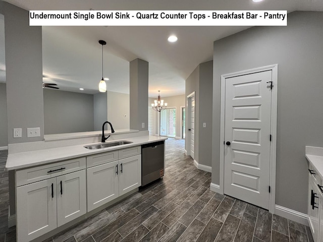 245 Cassady Ln, Crestview, FL 32539 - kitchen with stainless steel dishwasher, a chandelier, dark wood-style floors, light countertops, and hanging light fixtures