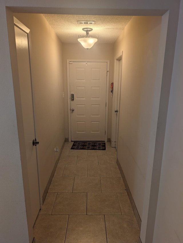 1809 Madelons Path, Fort Walton Beach, FL 32547 - doorway featuring a textured ceiling and light tile patterned flooring