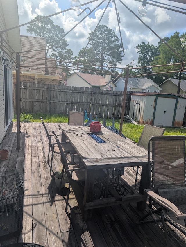 1809 Madelons Path, Fort Walton Beach, FL 32547 - deck with outdoor dining space, a shed, and a fenced backyard