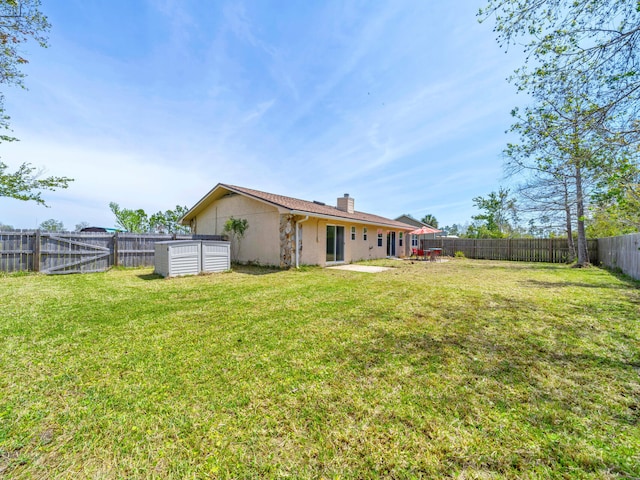 2016 E Three Putt Ln, Panama City, FL 32404 - rear view of house with a chimney, a fenced backyard, and a patio