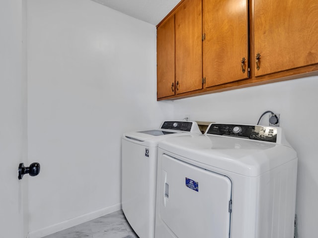 2016 E Three Putt Ln, Panama City, FL 32404 - laundry area with cabinet space, independent washer and dryer, and light marble finish flooring