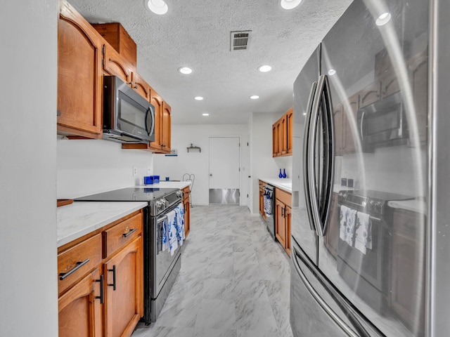 2016 E Three Putt Ln, Panama City, FL 32404 - kitchen with black appliances, brown cabinetry, recessed lighting, light stone counters, and a textured ceiling