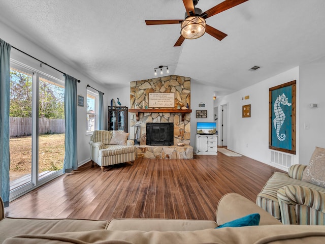 2016 E Three Putt Ln, Panama City, FL 32404 - living room featuring wood-type flooring, lofted ceiling, ceiling fan, and a fireplace