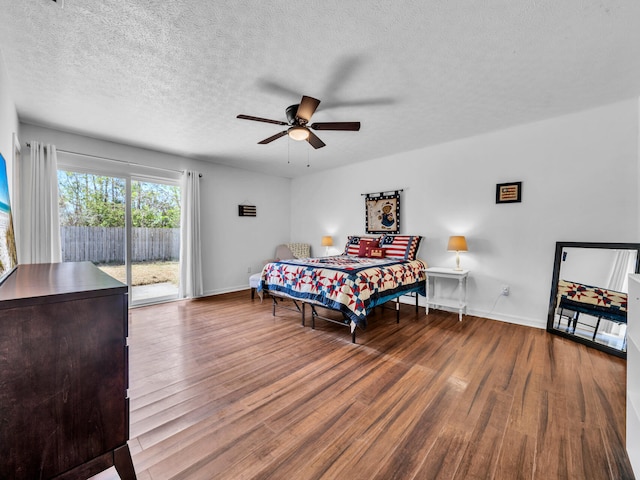 2016 E Three Putt Ln, Panama City, FL 32404 - bedroom featuring access to outside, wood finished floors, a textured ceiling, and a ceiling fan