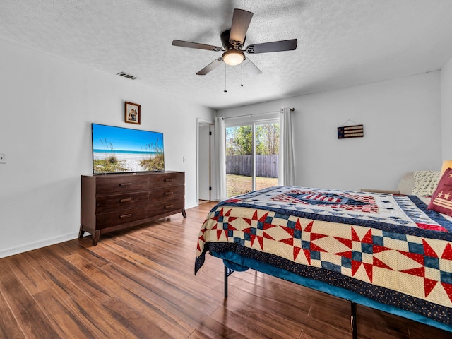 2016 E Three Putt Ln, Panama City, FL 32404 - bedroom with access to exterior, wood finished floors, a textured ceiling, and a ceiling fan