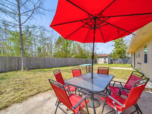 2016 E Three Putt Ln, Panama City, FL 32404 - fenced backyard with outdoor dining space, a patio area, and a shed