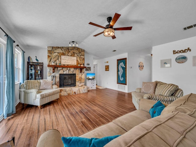 2016 E Three Putt Ln, Panama City, FL 32404 - living room featuring vaulted ceiling, ceiling fan, a fireplace, and wood finished floors