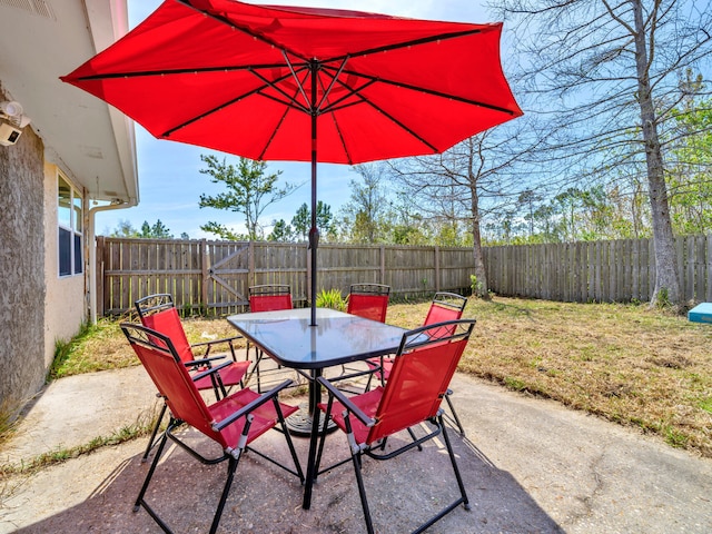 2016 E Three Putt Ln, Panama City, FL 32404 - fenced backyard with outdoor dining space and a patio
