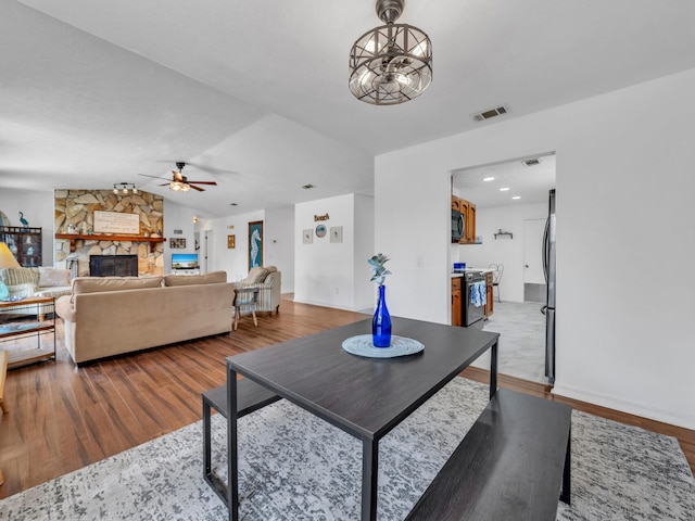 2016 E Three Putt Ln, Panama City, FL 32404 - living area with a fireplace, wood finished floors, a ceiling fan, and vaulted ceiling