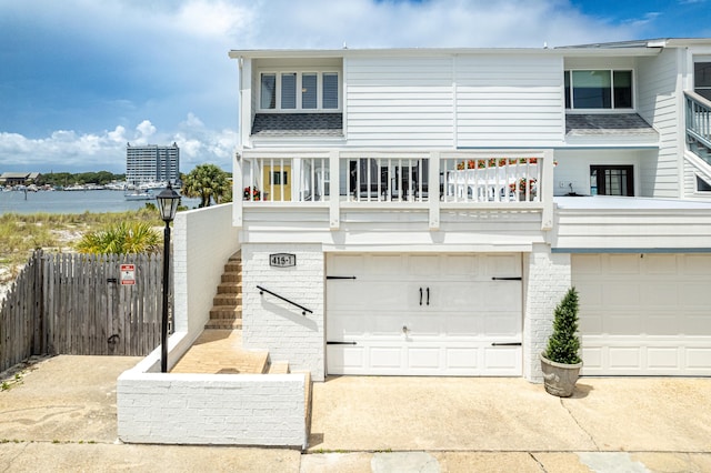 415 Gulf Shore Dr Unit 1, Destin, FL 32541 - view of front of home with a garage, a balcony, stairs, concrete driveway, and brick siding