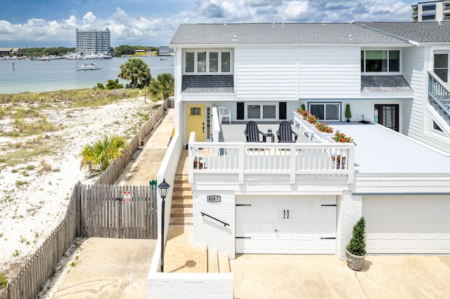 415 Gulf Shore Dr Unit 1, Destin, FL 32541 - multi unit property featuring driveway, an attached garage, a water view, and roof with shingles